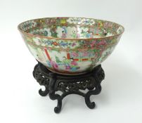 A 19th century Cantonese porcelain bowl, decorated with birds and trees on a carved
