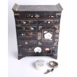 A Chinese black lacquered table cabinet, a silver salt pot and a silver shoe pin cushion, and a