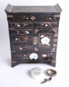 A Chinese black lacquered table cabinet, a silver salt pot and a silver shoe pin cushion, and a