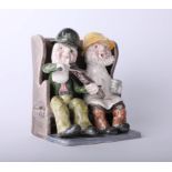 Alan Young Pottery, figures on a bench, height 15cm.
