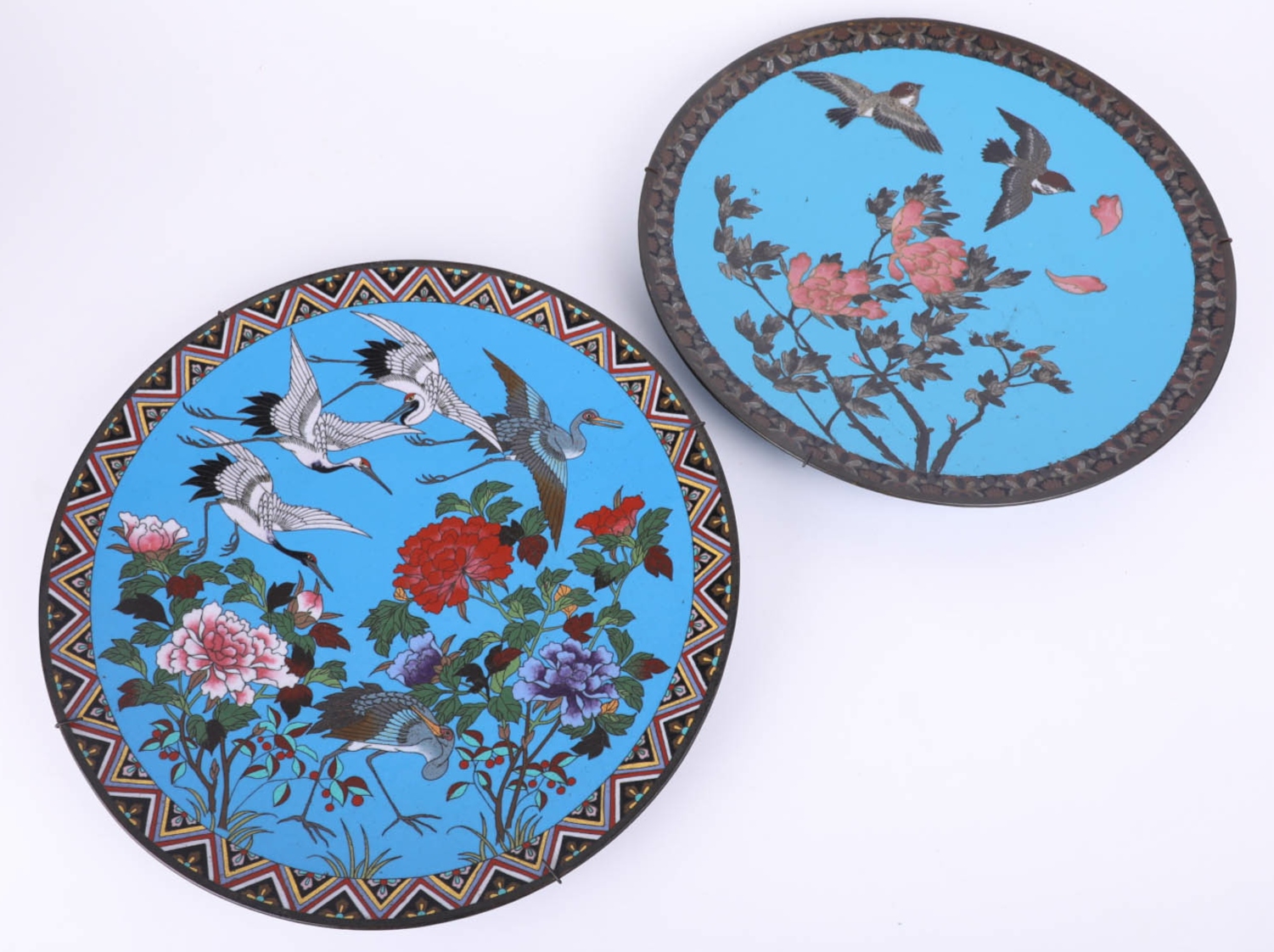 A pair of Japanese cloisonné wall plates on a blue ground (2),