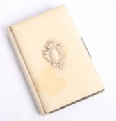 A vintage pocket notebook with ivory cover.