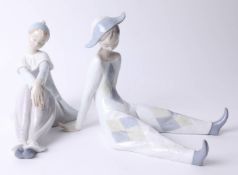 Two Lladro figures seated Harlequin and Columbine, boxed, height 20cm.