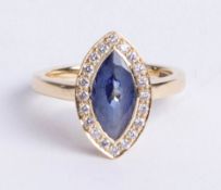 An 18ct yellow gold tanzanite and diamond cluster ring, the single tanzanite approx 2.14 carats, set