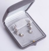 A fine pair of diamond drop earrings, each comprising four graduated diamonds, the largest approx