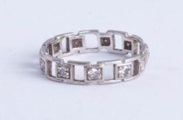 A platinum and diamond set eternity ring, open box design, size L.