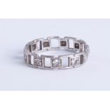 A platinum and diamond set eternity ring, open box design, size L.