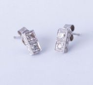 A pair platinum and diamonds set earrings,