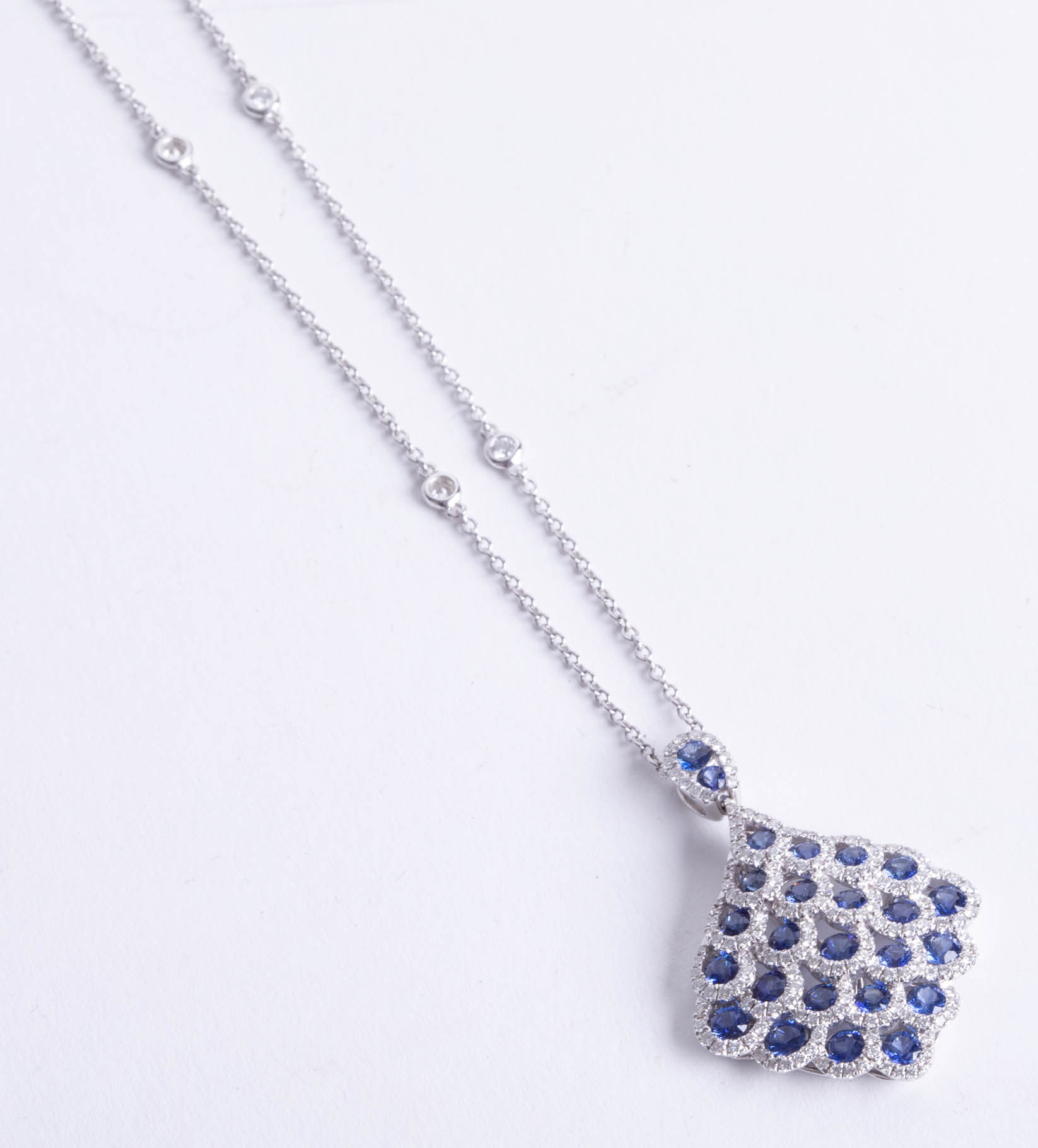 A fine 18ct white gold diamond and sapphire pendant and chain.