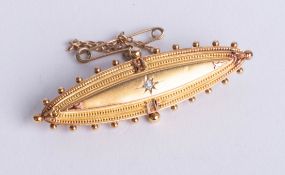 A 15ct gold brooch, set with a single diamond, length 50mm, boxed.