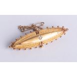 A 15ct gold brooch, set with a single diamond, length 50mm, boxed.