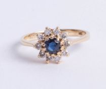 A 14ct (marked 585) sapphire and diamond cluster ring, approx 25 points, size J.