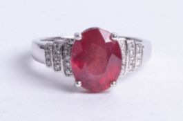 A 14k white gold and diamond ring set with an oval cut red gemstone approx 4.32 carats, diamonds