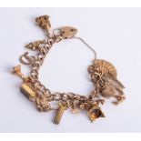 A charm bracelet set with 9ct and yellow metal charms, approx 45.50g.