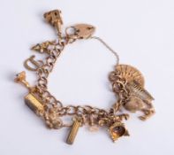 A charm bracelet set with 9ct and yellow metal charms, approx 45.50g.