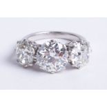 A fine large graduated diamond three stone ring, set with three old brilliant cut diamonds, centre