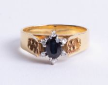 An 18ct diamond and sapphire ring, size S.