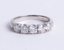 A platinum and diamond five stone ring, new circa 2010, size L/M.