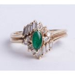 A 14k gold emerald and diamond cluster ring, size O.