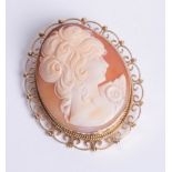 Large 9ct yellow gold oval cameo brooch with openwork scroll design and bead mount.