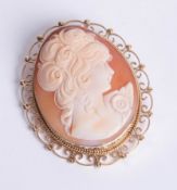 Large 9ct yellow gold oval cameo brooch with openwork scroll design and bead mount.