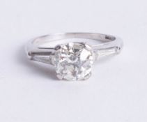 A fine platinum diamond solitaire ring, the centre old cut diamond approx 2 carats, two further