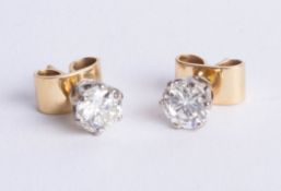 An impressive pair of diamond stud earrings, set in yellow gold, total diamond weight approx 2.05