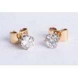 An impressive pair of diamond stud earrings, set in yellow gold, total diamond weight approx 2.05