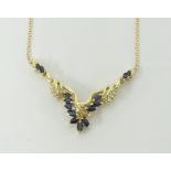 A 14k sapphire and diamond necklet set in yellow gold.