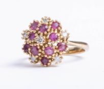 An 18ct ruby and diamond 16 stone cluster ring, size N.