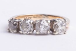 An 18ct four stone diamond ring, set with old cut round diamonds, size M.