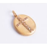 Oval antique locket. 15ct gold brushed finished with seed pearl set cross to front.