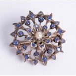 An unmarked yellow metal sapphire and pearl set open circular flower brooch, diameter 34mm.
