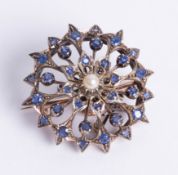 An unmarked yellow metal sapphire and pearl set open circular flower brooch, diameter 34mm.