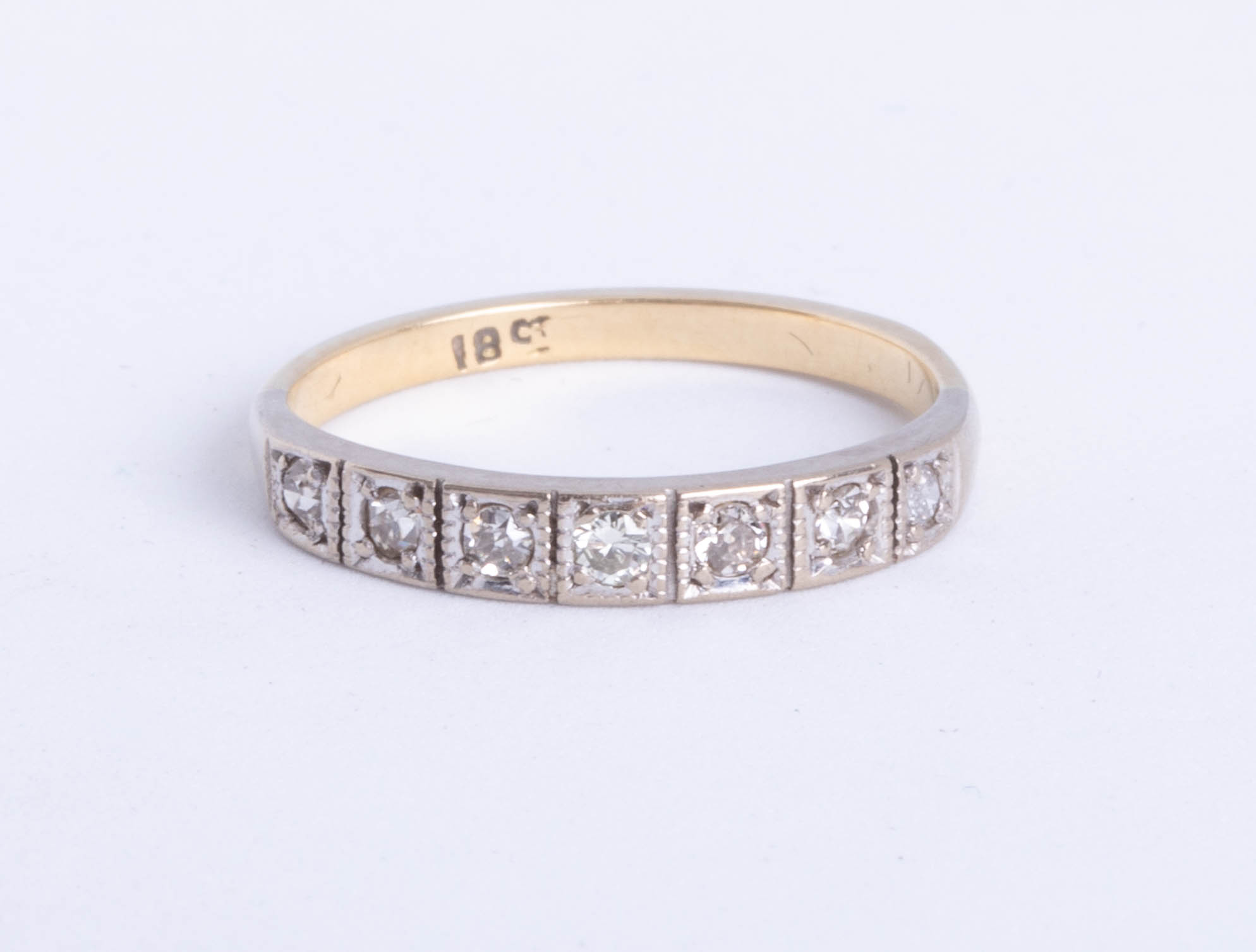 A diamond set half band eternity ring, size P.