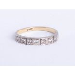 A diamond set half band eternity ring, size P.