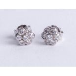 A pair of platinum and diamond set cluster earrings, diameter 6mm.