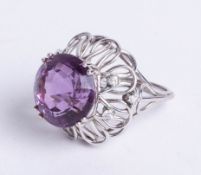 A large unmarked, white gold? seven stone amethyst and diamond cluster ring, size M.