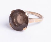 A 9ct round smoky quartz single stone ring, size N.