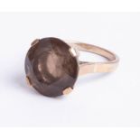 A 9ct round smoky quartz single stone ring, size N.