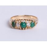 An 18ct yellow gold antique five stone ring. comprising three turquise stones, divided by two old