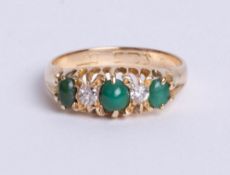 An 18ct yellow gold antique five stone ring. comprising three turquise stones, divided by two old