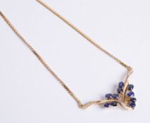 An 18ct yellow gold sapphire and diamond necklet, comprising ten oval cut sapphires of good colour