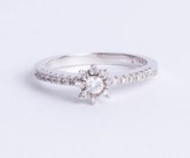 An 18ct white gold and diamond set flower ring, size Q.