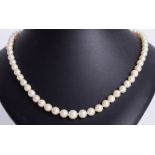 A single row, graduated cultured pearl necklet with silver ball clasp.