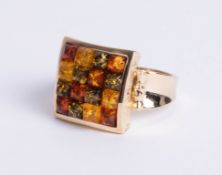 A 14ct yellow gold square dress ring, comprising four rows of four mixed colured amber stones cut