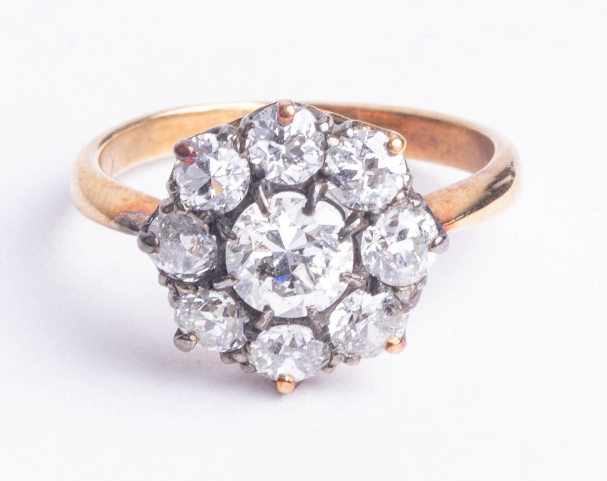 An 18ct nine stone diamond cluster ring, size K.