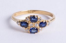 An 18ct yellow gold cluster ring set with four sapphires and diamonds, size T.