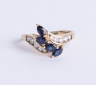 A 9ct sapphire and diamond set ring, set with four royal blue marquise cut sapphires with central