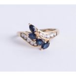 A 9ct sapphire and diamond set ring, set with four royal blue marquise cut sapphires with central